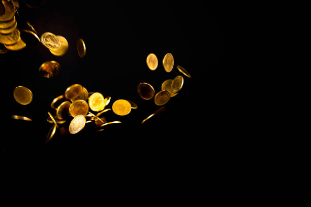 istock Falling gold coins money in dark background, business concept. 961077892