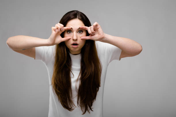 istock Portrait of emotional puzzled plus size model standing in studio looking in camera showing funny gesture 961080192