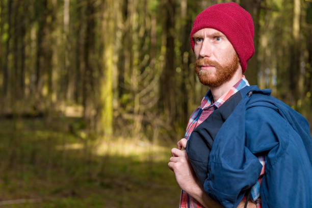 istock man with a beard in a hat posing in the forest 961081074