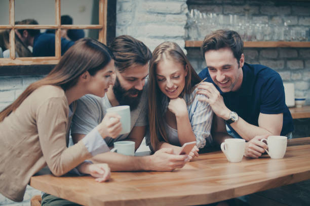 istock Four people looking at the phone 961081342