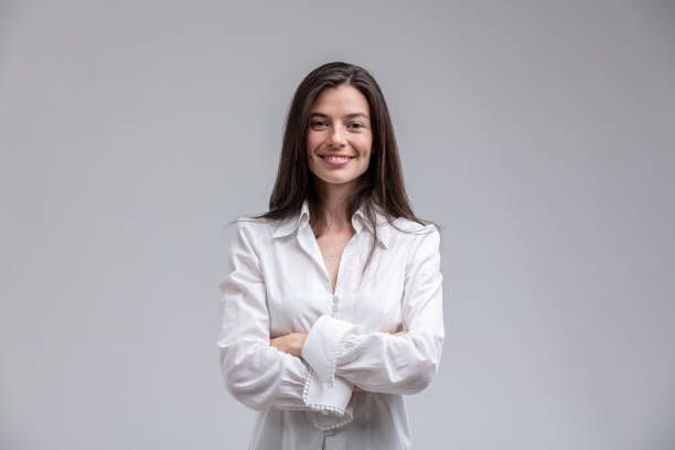 Smiling woman standing with arms crossed
