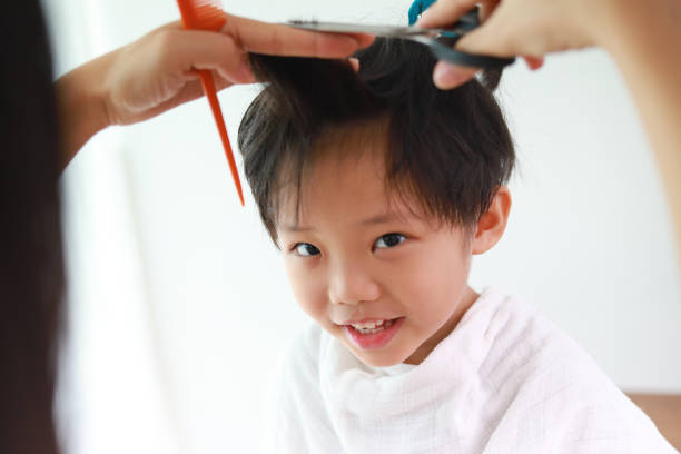 istock Mother giving son haircut 961102938