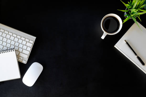istock Office leather desk table with desktop computer, supplies, coffee cup and flower. Top view with copy space 961113950