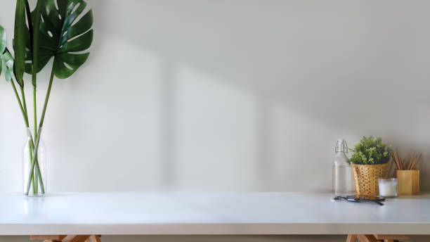 istock Workspace and copy space, white wood table with plant, coffee cup and stuff. 961113974