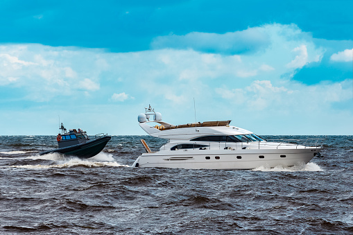 White speed boat moving fast to the Baltic sea. Water sport