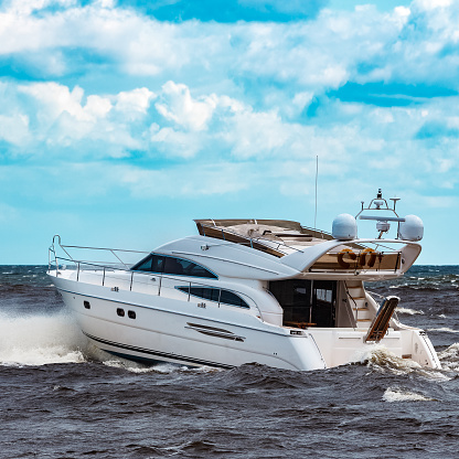 White speed boat moving fast to the Baltic sea. Water sport