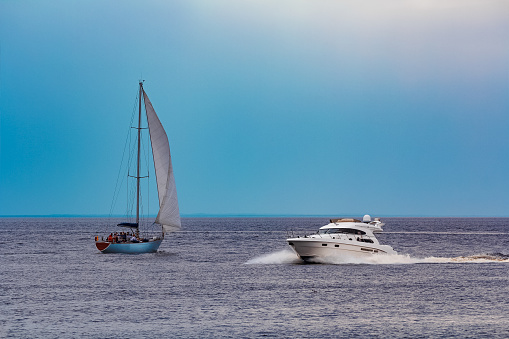 White speed boat moving fast to the Baltic sea. Water sport