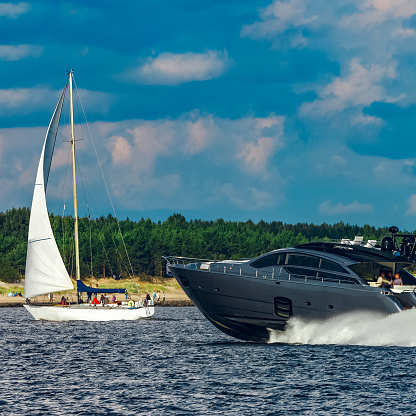 Grey speedboat moving fast by the river in Latvia. Water sport