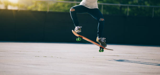 istock Skateboarder skateboarding at city 961139118