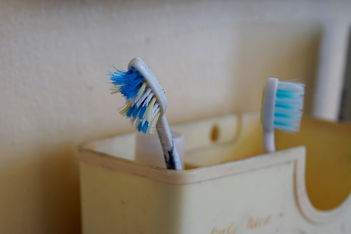 old toothbrush in plastic containers.