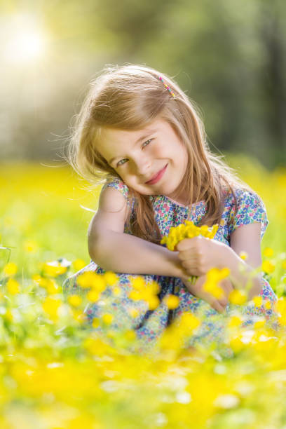 istock Happy little girl on blooming meadow 961155616