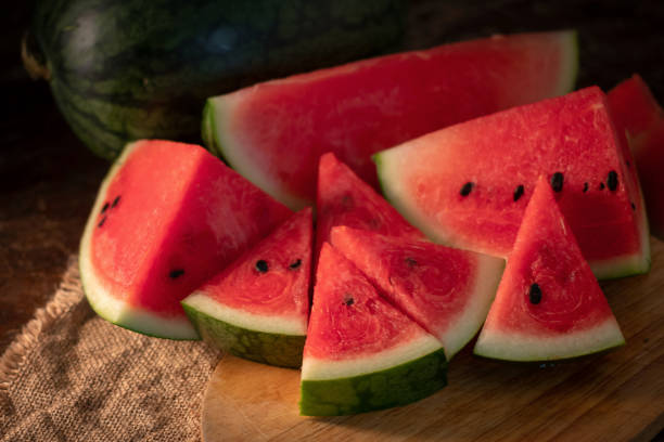 istock watermelon and watermelon pieces in a wooden background 961166400