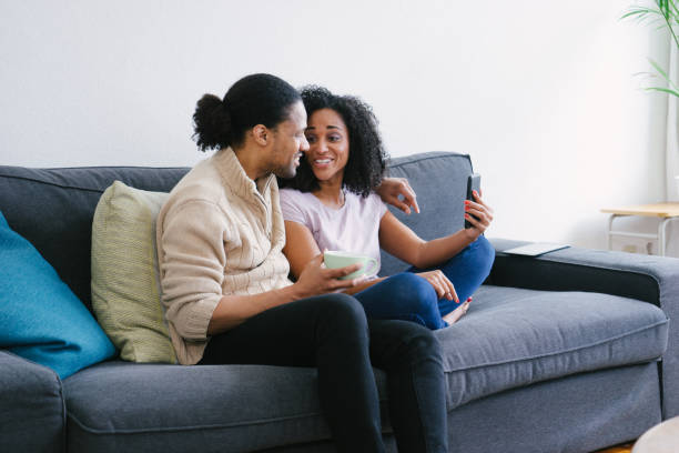 istock Young beautiful couple sharing coffee on sofa 961167246