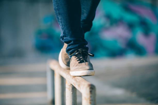 istock Legs walking on steel pipe with balance 961172430