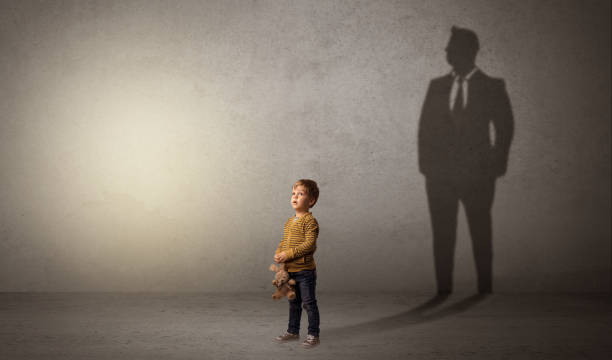 istock Little boy with businessman shadow 961177162