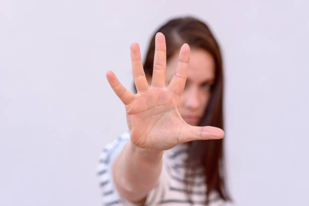 istock Young woman with hand in front of face 961177466