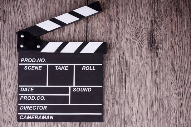 istock holding clapper board or slate film concept On wooden table. 961177668