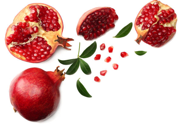 istock pomegranate fruit with green leaves isolated on a white background top view 961178378
