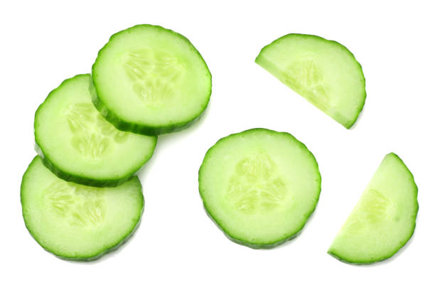 istock fresh cucumber slices isolated on white background. top view 961178396
