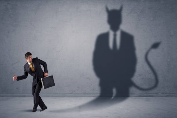 istock Business man looking at his own devil demon shadow concept 961182444