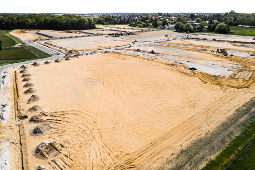 Aerial view of the planum for a new housing estate in Wolfsburg, with already completed roads and the sewerage system, near Reislingen