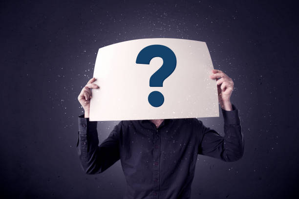 istock Businessman holding paper with question marks 961200812