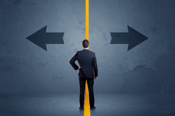 istock Business person choosing between two options separated by a yellow border arrow 961202010