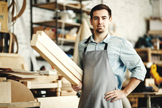 istock Young carpenter shop owner