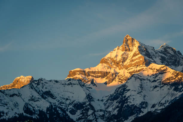 Beautiful dawn light hits the face of Cime de l'est (Dent noire) on the Dents du midi, a famous peak in the Swiss alps near the ski resort of Champery