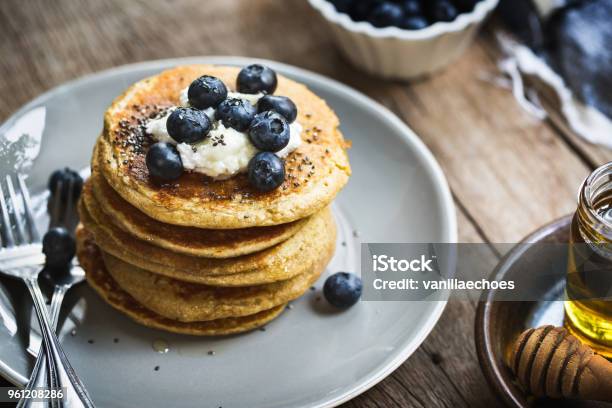 Banana Oat Pancakes With Blueberries Coconut Cream And Chia Topping Stock Photo - Download Image Now