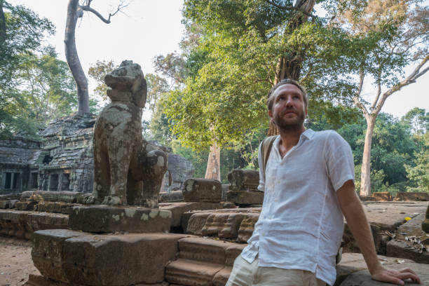 istock Young man contemplating ancient temple in Cambodia 961208748