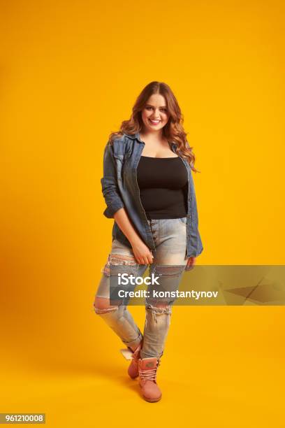 Joyful Curvy Girl In Casual Outfit Posing At Studio Stock Photo - Download Image Now