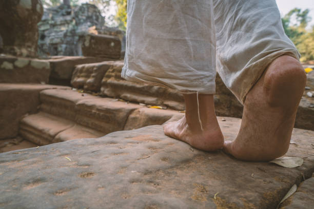 istock Close up on woman's barefoot walking on ancient temple in Cambodia, Angkor Wat 961210108