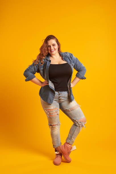 istock Candid plump girl posing with her hands on her hips 961210122