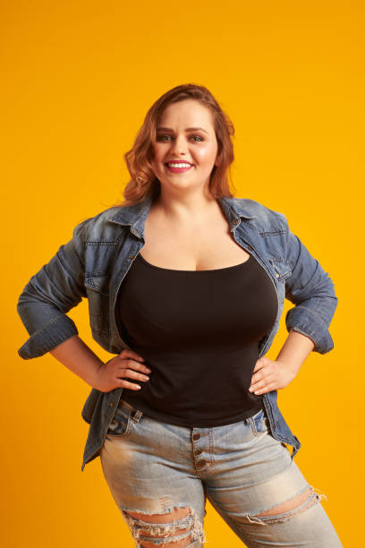istock Beautiful plus-size model with big breast smiling at camera 961210154