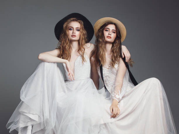 istock Beautiful brides in wedding dresses and hats 961215614