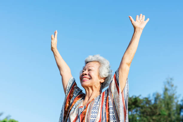 istock Senior woman raising her hands 961217356