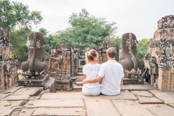 istock Young couple contemplating ancient temple in Cambodia, Angkor Wat 961222738