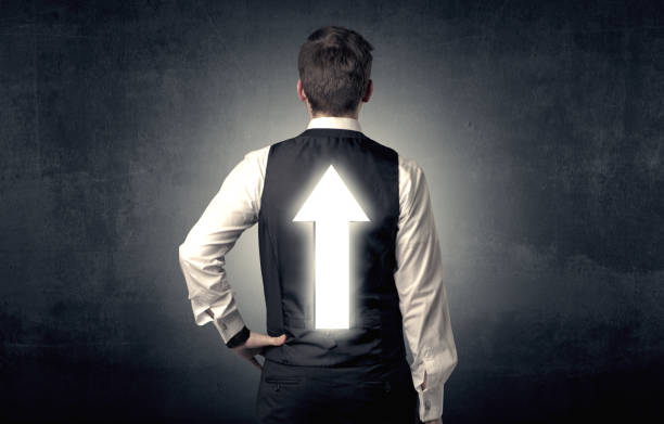 istock Young businessman standing with arrow on his back 961226312