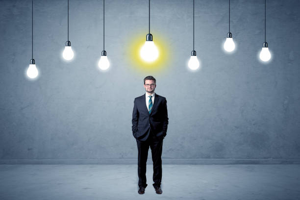 istock Businessman standing uninspired with bulbs above 961227338