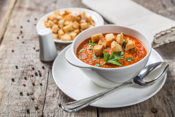 istock Tomato soup on a table of old wooden boards.  Copy-space. 961231194