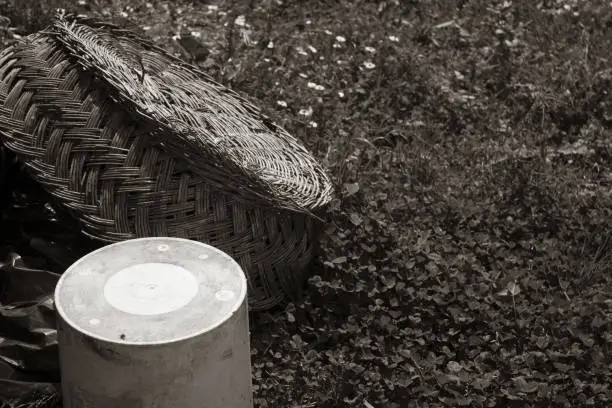 Photo of sepia effect Braided hemp basket resting on the ground