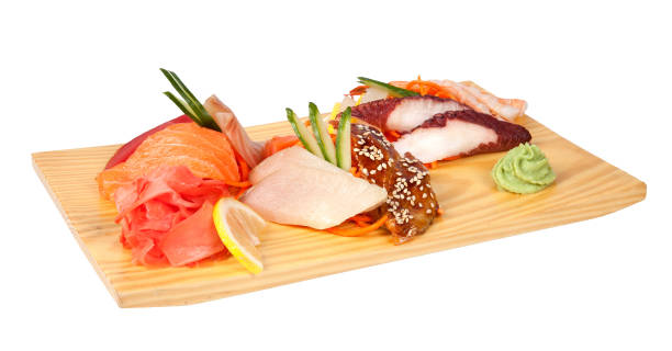 istock Sashimi set with perch, rudderfish, tuna, squid, octopus, shrimps and eel on wooden board with wasabi and lemon 961239582