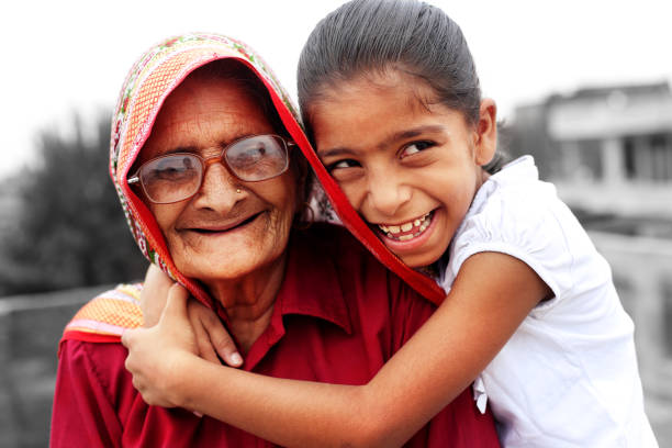 Happy old grandmother with her granddaughter loving portrait on white background.