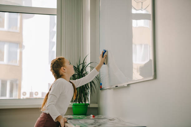 istock little child wiping whiteboard with sponge 961244466