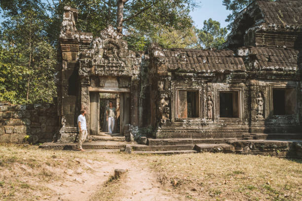 istock Young couple contemplating ancient temple in Cambodia 961248994