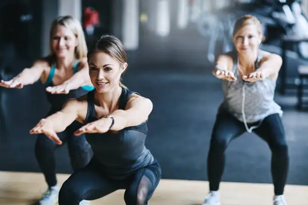 Cropped shot of three attractive and athletic women working out in the gym
