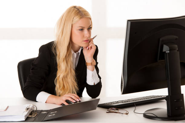 Beautiful young girl is working in a bright office. photo with depth of field.