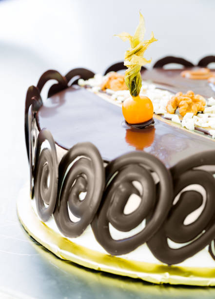 istock Chocolate glazing cake with orange physalis fruit 961256462