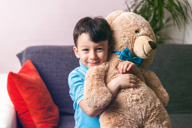 Cute child and teddy bear stock photo